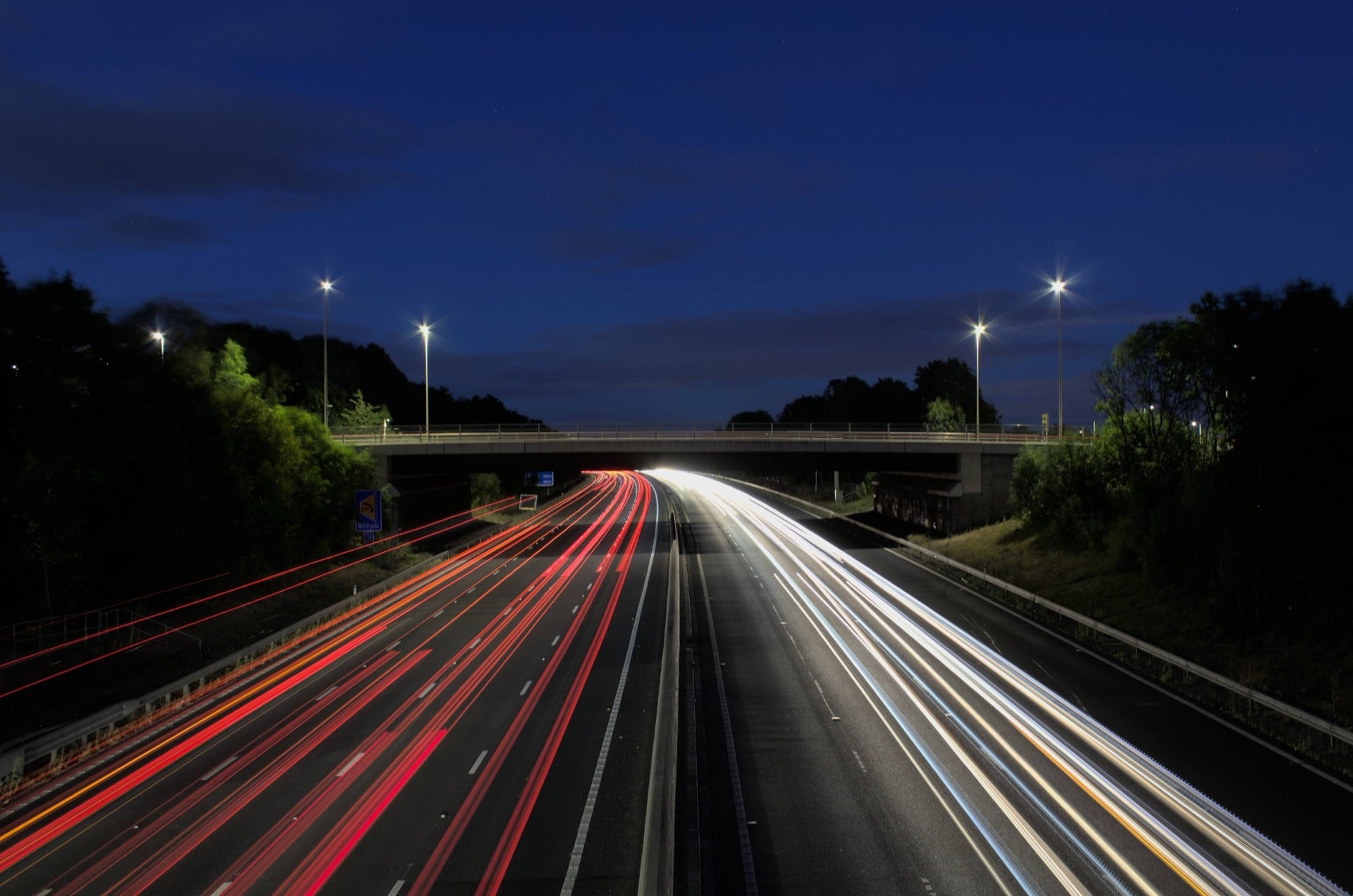 Highway light trails at night representing fast logistics distribution